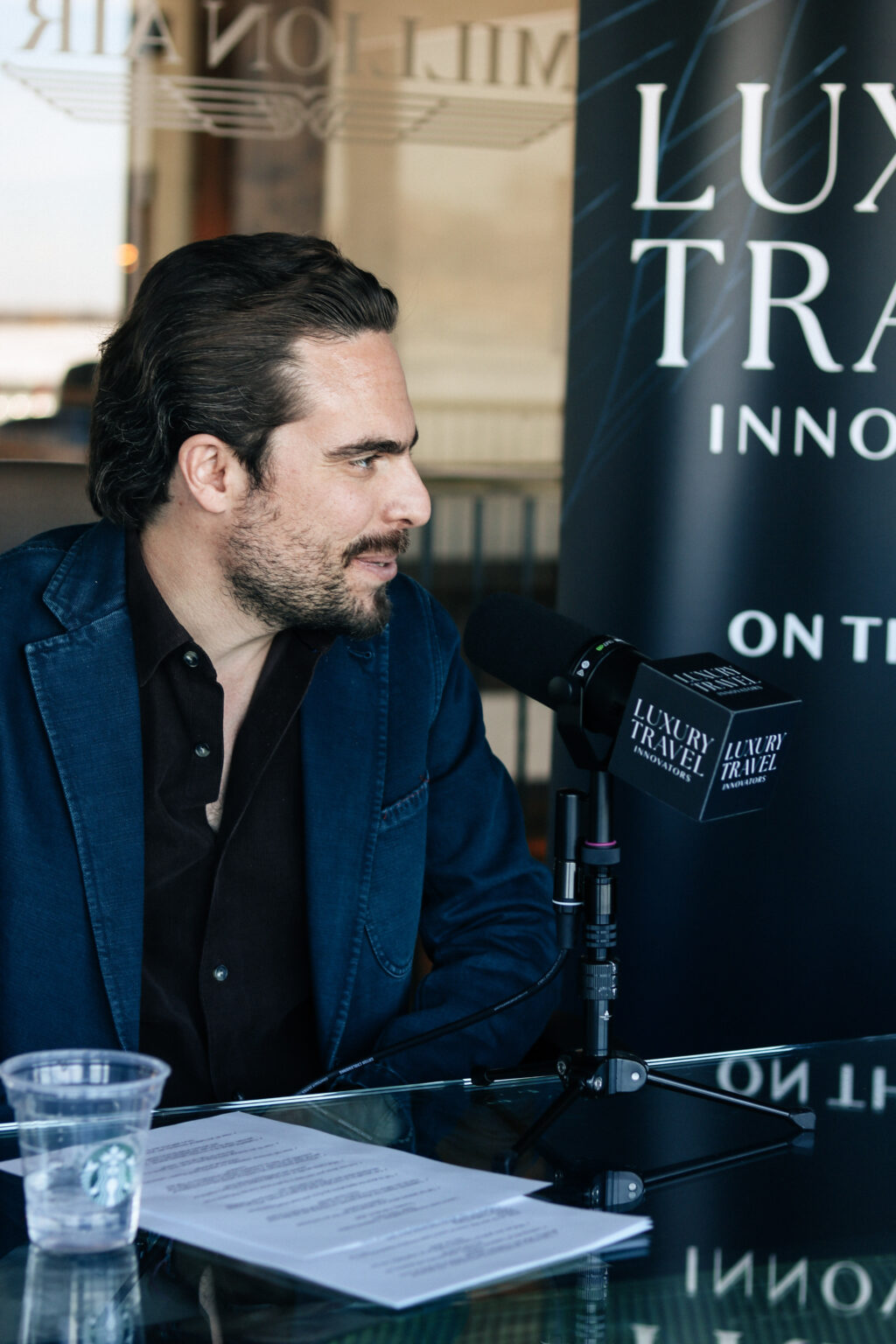 Adam Deflorian recording episode 29 of the Luxury Travel Innovators podcast.