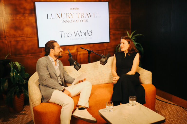 Adam Deflorian and Jessica Hoppe sit on a sofa during episode 40 of Luxury Travel Innovators.