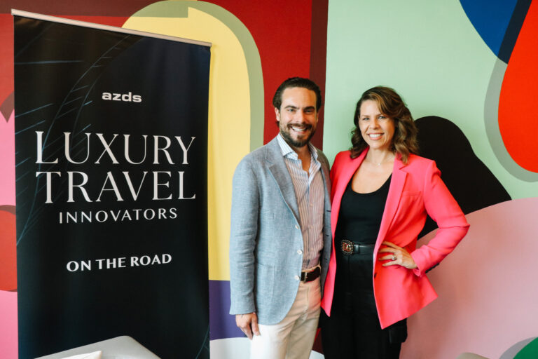 Adam Deflorian and Janet Bava next to the Luxury Travel Innovators On the Road sign.